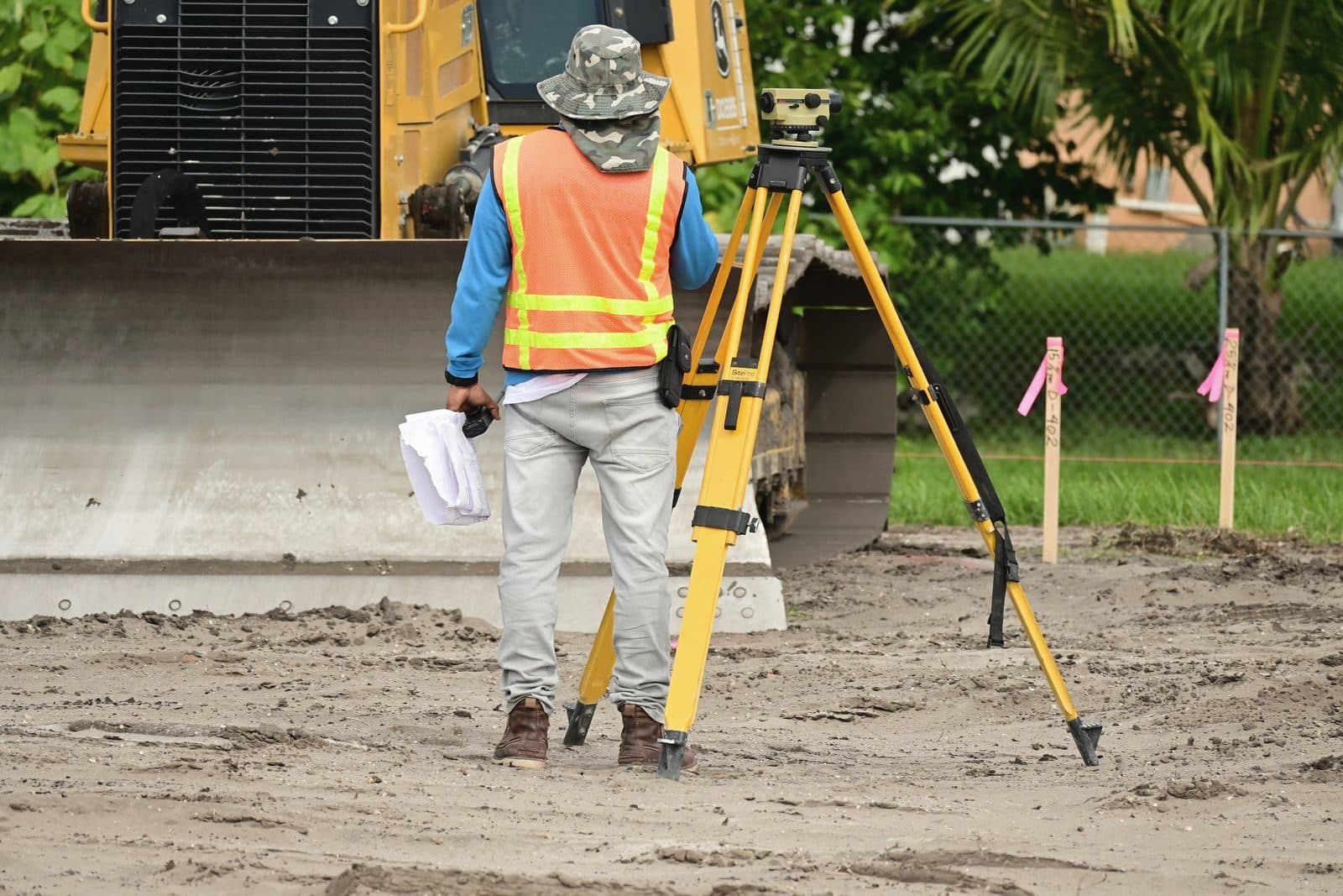 Surveyor with a total station measuring land on site
