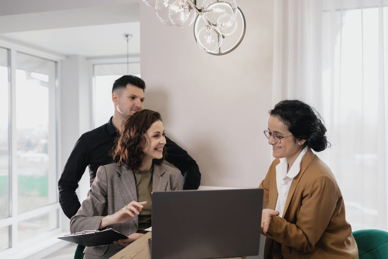 Real estate consultants meeting with clients in a bright office